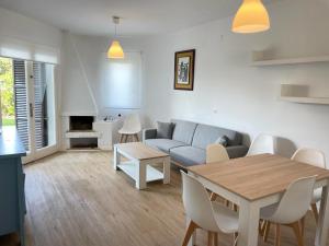 a living room with a couch and a table at Sa Posta De Sol in Cala en Blanes