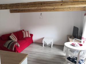 a living room with a red couch and a table at Red Bed in Jankowice