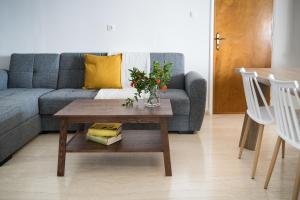 a living room with a couch and a table with flowers at Phaedrus Living Sea View Villa Aegina in Perdhika
