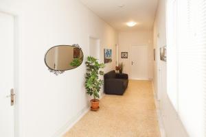 a hallway with a mirror and a couch at Ioannis Apartments in Athens