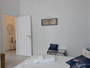 a bedroom with a bed and a clock on the wall at Una finestra sul mare Home 1 in Bergeggi +45 photos