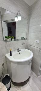 a bathroom with a white sink and a mirror at Casa Diana in Augusta +16 photos