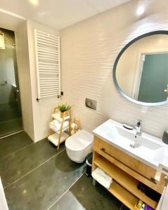 a bathroom with a sink and a toilet and a mirror at MONI Downtown Luxury Apartments in Belgrade +20 photos