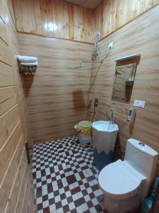 a bathroom with a toilet and a sink at MR River Resort in Rishīkesh