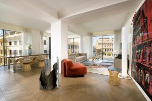 a living room filled with furniture and a large window at Hotel Palazzo Manfredi – Small Luxury Hotels of the World in Rome