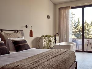 a bedroom with a large bed and a large window at Contessina Hotel in Tsilivi