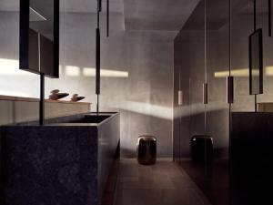 a kitchen with black cabinets and a floor at Acro Suites - A Wellbeing Resort in Agia Pelagia