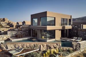 an image of a house with a swimming pool at Acro Suites - A Wellbeing Resort in Agia Pelagia