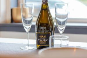 eine Flasche Wein und zwei Gläser auf einem Tisch in der Unterkunft ENTIRE Lovely Scottish Cottage in Selkirk + 19 Fotos