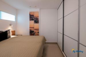 a bedroom with a bed and a sliding glass door at Esther's Sea View in Playa del Ingles