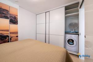 a bedroom with a washing machine in a closet at Esther's Sea View in Playa del Ingles +6 photos