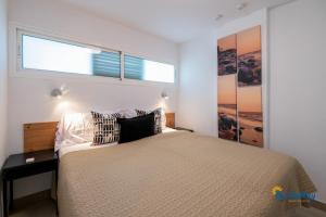 a bedroom with a large bed and a window at Esther's Sea View in Playa del Ingles