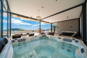 a hot tub in a room with large windows at Hotel Millennium by Aycon in Budva