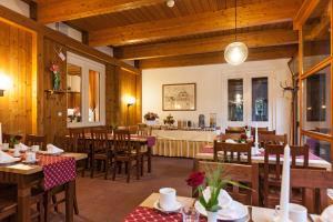 a restaurant with wooden walls and tables and chairs at Schlossrestaurant Neuschwanstein in Hohenschwangau