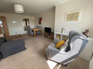 a living room with a couch and a chair at The Lookout in Cellardyke