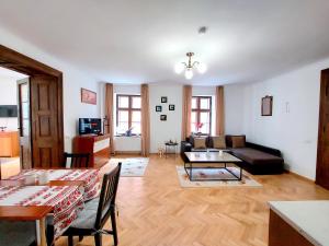 a living room with a couch and a table at Casa Roth in Braşov