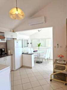 a kitchen with white appliances and a table and chairs at Apartment ANGIE - Marjan Hill in Split