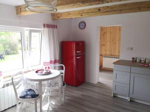 a kitchen with a table and a red refrigerator at Red Bed in Jankowice