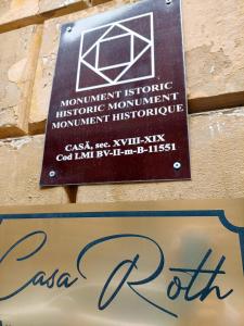 a sign for amonthistoric historic monuments monumentitschroute at Casa Roth in Braşov