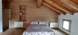 a bedroom with a bed and a wooden wall at Agriturismo l'Eremo in Volpago del Montello