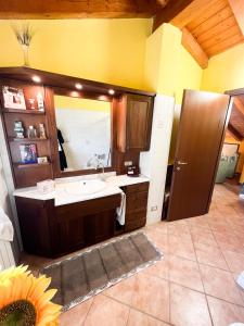 a bathroom with a sink and a mirror at La maison di Gio & Gio in Olgiate Comasco