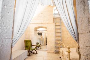 a room with a staircase in a brick wall at Trullo Antica Bellezza in Alberobello