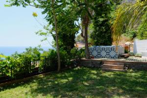 a garden with a bench and a fence at Casa Paradiso - Panoramic Sea View & Jacuzzi in Terracina +55 photos