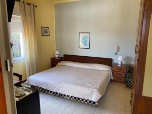 ein kleines Schlafzimmer mit einem Bett und einem Fenster in der Unterkunft Hotel Nettuno in Diano Marina