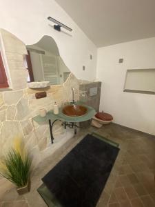 a bathroom with a sink in a stone wall at Apartmany Vila Lucia 6 in Pilsen
