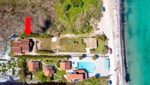 an aerial view of a house next to the beach at Villa Yiannitsis-Harmony In The Flowers, Acharavi Beach in (( Litherés ))