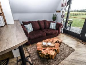 a living room with a couch and a table at Silver Birch Lodge in Bawtry
