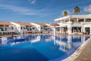 a swimming pool in front of a resort at Cheap & Chic Apartamentos en Son Bou de 2 dormitorios in Son Bou