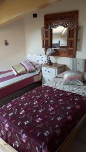 a bedroom with two beds and a mirror at Appartamento centro storico in Riva del Garda