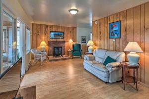 a living room with a couch and a fireplace at Lakefront Broadalbin Getaway with Deck and Kayaks in Broadalbin