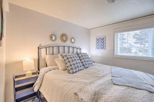 a bedroom with a bed and two mirrors on the wall at Rockaway Beach Condo - Beach Access Nearby! in Rockaway Beach
