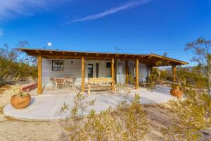 a small house with a patio and a table at Flying Point Homestead in Twentynine Palms