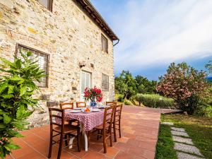 a patio with a table and chairs in front of a building at Residence al Foionco in Lucca