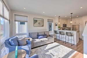 a living room with a couch and a kitchen at Traverse City Townhome Walk to Beach! in Traverse City