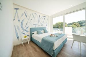 a bedroom with a bed and a large window at Rodi Resort in Rodi Garganico