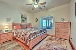 a bedroom with a bed and a ceiling fan at Bring a Pet Happy Jack Cabin with Fire Pit! in Happy Jack