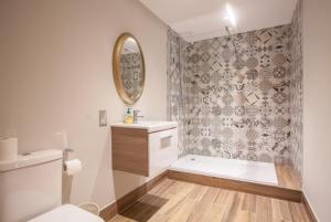 a bathroom with a toilet and a sink and a mirror at Stylish 2 Bedroom Apartment In Park Circus, West End in Glasgow