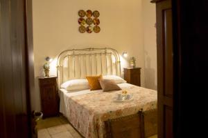 a bedroom with a bed and a lamp at B&B Sabir in San Vito lo Capo