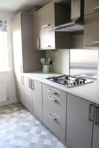 a kitchen with white cabinets and a stove at The Lookout in Cellardyke