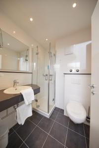 a bathroom with a toilet and a sink and a shower at Hotel Filderland - Stuttgart Messe - Airport - Self Check-In in Leinfelden-Echterdingen