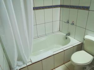 a bathroom with a white tub and a toilet at Hotel Bosque Verde Lodge in Monteverde Costa Rica