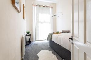 a bedroom with a bed and a window at Cozy Coastal Getaway in North Shields