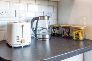 a kitchen counter with a blender on a counter top at Cozy Coastal Getaway in North Shields