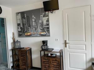 a room with a door and a tv on the wall at La maison du bonheur avec clim reversible in Larçay