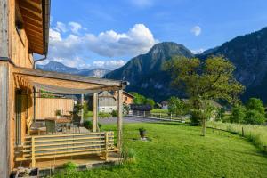 a house with a deck with a view of mountains at Ferienlodge MaResi in Bad Goisern
