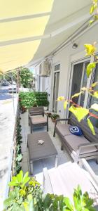 a patio with benches and plants on a building at Sea & Sun cozy studio in Kremasti +11 photos